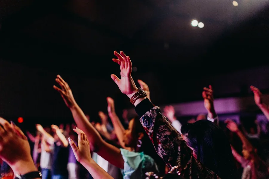 Hands raised during a worship gathering
